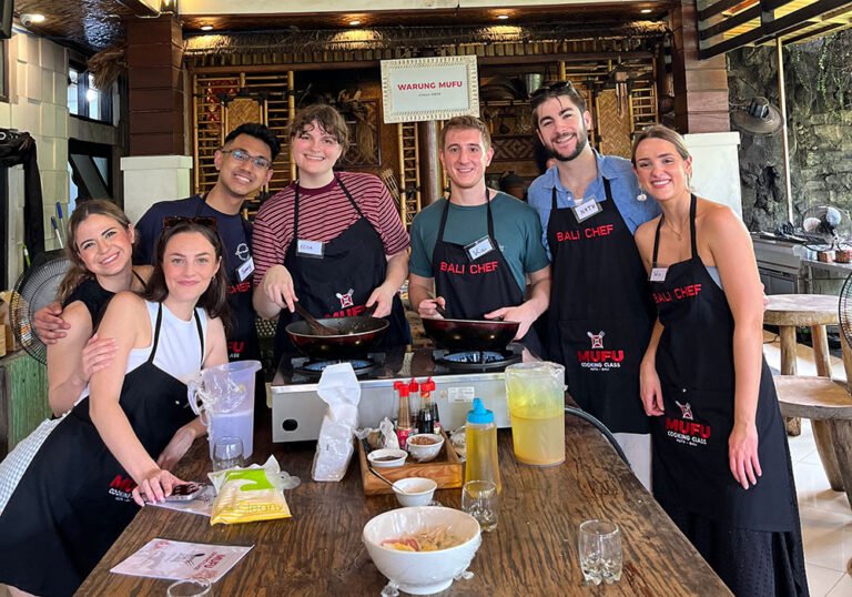 Local instructor guiding guests during a Bali cooking class at Warung Mufu