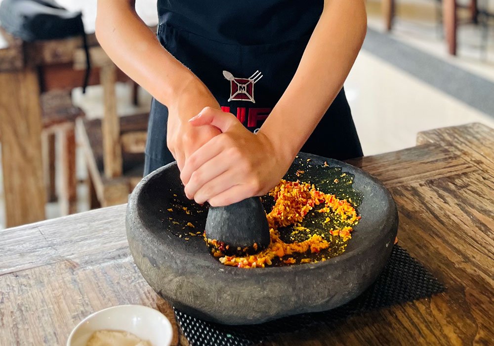 Guests discovering fresh local ingredients during a traditional market tour in Kuta